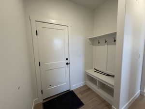 Mudroom with baseboards and light wood-type flooring
