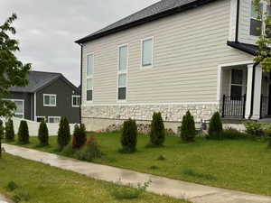 View of property exterior featuring a yard