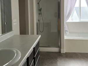 Bathroom with a shower stall, a textured ceiling, vanity, and a bath