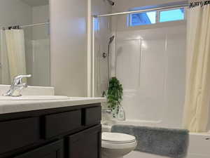 Full bath with shower / bath combo, toilet, and vanity