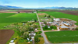 Aerial view of sparsely populated area featuring extensive farmland and a mountain backdrop