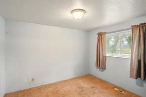 Empty room with carpet floors