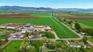 View of rural area with a mountainous background and large plots for crops