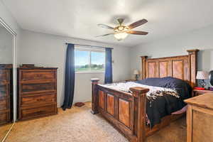 Bedroom with light colored carpet and ceiling fan