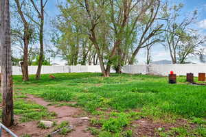 View of yard featuring fence