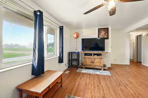 Living room featuring a ceiling fan and light wood-type flooring