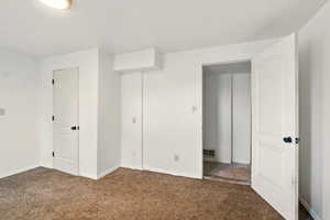 Unfurnished bedroom featuring carpet and baseboards