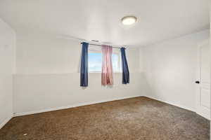 Unfurnished room featuring carpet flooring and baseboards
