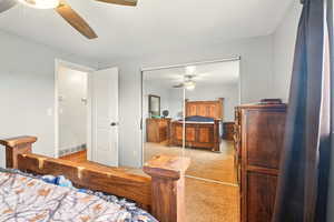 Bedroom featuring carpet floors, a closet, and a ceiling fan