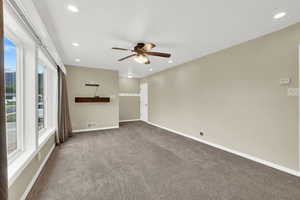 Empty room featuring carpet, ceiling fan, recessed lighting, and baseboards