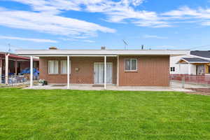 Rear view of house with a patio area and brick siding