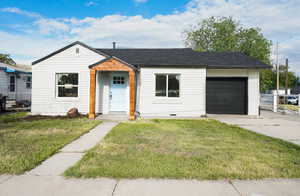 View of front of house featuring a garage, concrete driveway, and a shingled roof