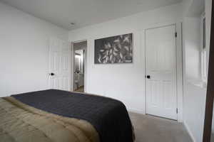 Carpeted bedroom featuring baseboards
