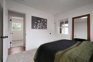 Bedroom featuring carpet floors and baseboards
