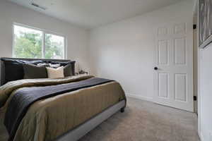 Bedroom featuring carpet flooring and baseboards