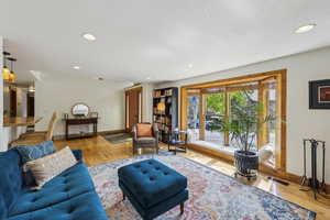Living area featuring wood finished floors, recessed lighting, and baseboards