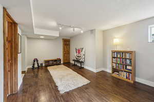 Sitting room with rail lighting, baseboards, dark wood-style floors, and recessed lighting