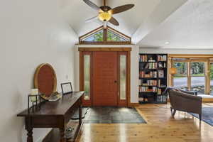 Foyer featuring vaulted ceiling, healthy amount of natural light, and a ceiling fan