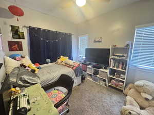 Carpeted bedroom with ceiling fan