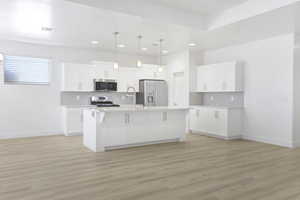 Kitchen with appliances with stainless steel finishes, a sink, backsplash, light countertops, and recessed lighting