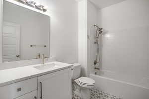 Full bath with toilet, vanity, and shower / tub combination