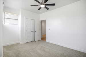 Unfurnished bedroom with carpet flooring, baseboards, a closet, and ceiling fan