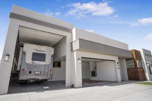 View of front of property featuring stucco siding and an attached garage