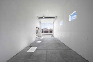 Hallway featuring concrete flooring and healthy amount of natural light