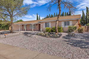 Single story home featuring fence and brick siding