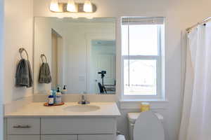 Full bath featuring vanity and toilet