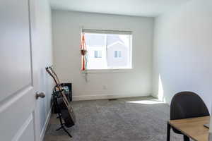 Office area featuring carpet floors and baseboards