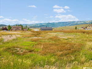 View of mountain backdrop featuring rural landscape