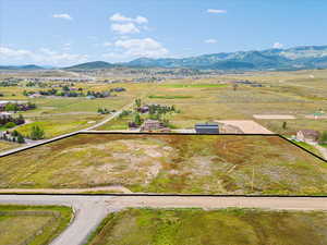 Overview of rural landscape featuring property boundaries highlighted and a mountainous background