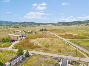 Overview of rural landscape featuring a mountain backdrop