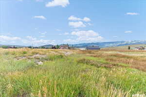Water view featuring rural landscape and a mountain backdrop