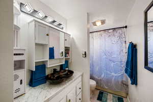 Full bath with toilet and vanity