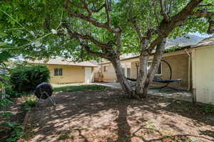 Back of property with brick siding, a patio, and a mountain view