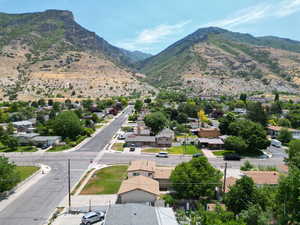 View of mountain backdrop featuring nearby suburban area