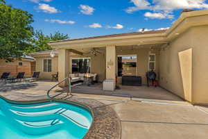View of swimming pool with an outdoor living space, a patio area, fence, and a ceiling fan