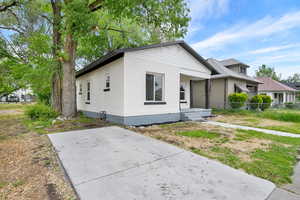 View of front of property featuring brick siding and fence