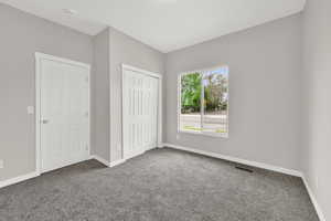 Unfurnished bedroom with carpet flooring, baseboards, and a closet