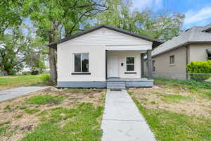 View of front facade with a porch and brick siding