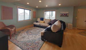 Living room featuring vinyl floors, daylight windows, and recessed lighting