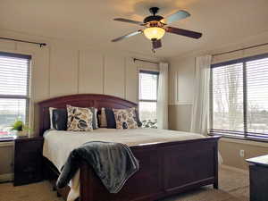 Master bedroom with ornamental molding, and ceiling fan