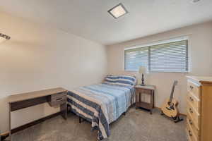 Carpeted bedroom featuring baseboards
