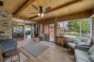 Sunroom with an outdoor hangout area, beamed ceiling, and a ceiling fan