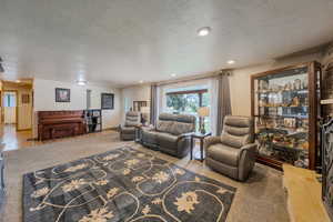 Living room featuring a textured ceiling and recessed lighting