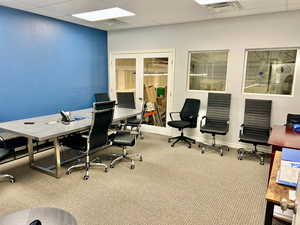Office area featuring carpet and a paneled ceiling