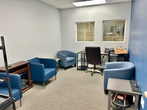 Carpeted office space with a paneled ceiling