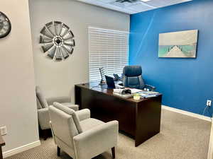 Home office with carpet floors and baseboards